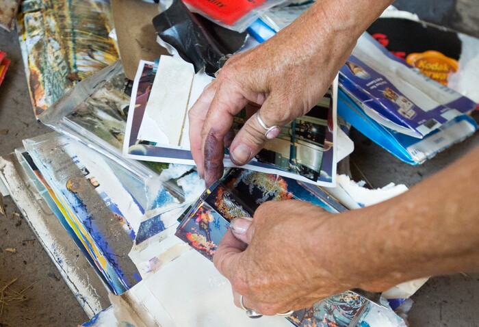 (Rick Egan  |  The Salt Lake Tribune)  Emmy Thomson sorts through photos that were destroyed when water flooded her garage, at her home on Lincoln Street. Tuesday, August 1, 2017.