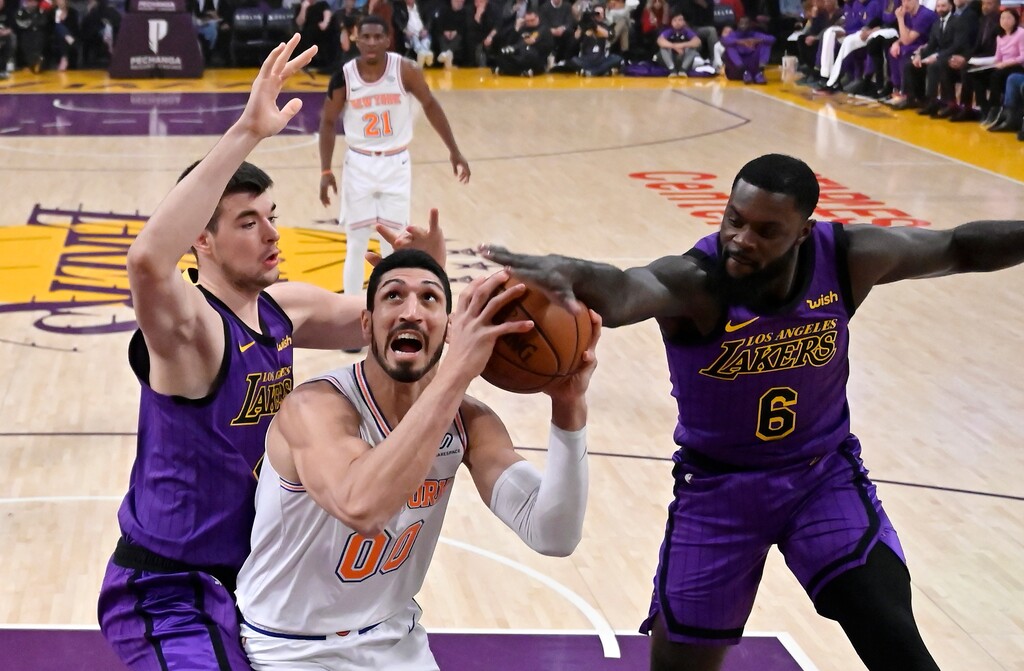 New York Knicks center Enes Kanter, center, tries to shoot as Los Angeles Lakers center Ivica Zubac, left, and guard Lance Stephenson defend during the first half of an NBA basketball game Friday, Jan. 4, 2019, in Los Angeles. (AP Photo/Mark J. Terrill)