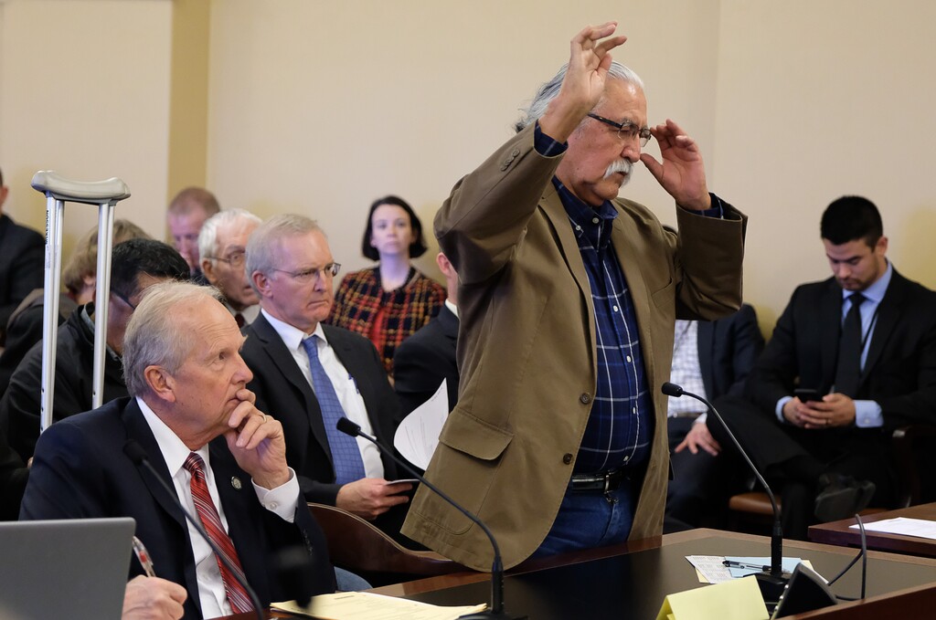 (Francisco Kjolseth  |  The Salt Lake Tribune)  Utah Navajo Dine Bikeyah member Willie Grayeyes is asked to swear in before his testimony in opposition to HB136, sponsored by Rep. Mike Noel, R-Kanab, at left, which muzzles city and local officials from speaking out on public-lands protections during the House Natural Resources, Agriculture, and Environment Standing Committee at the Capitol on Tuesday, Feb. 6, 2018.