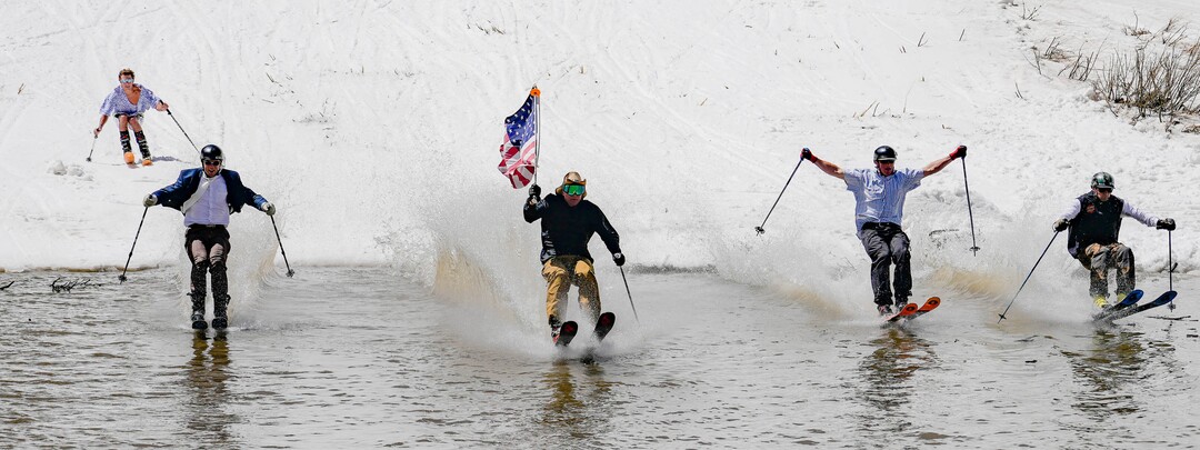(Francisco Kjolseth  | The Salt Lake Tribune) Skiers skim the pond in Peruvian Gulch as Snowbird closes the book on the 2024-25 ski season on Monday, May 26, 2025. Snow and sun revelers took to the slushy slopes on Memorial Day as the resort was the last in the state to close.