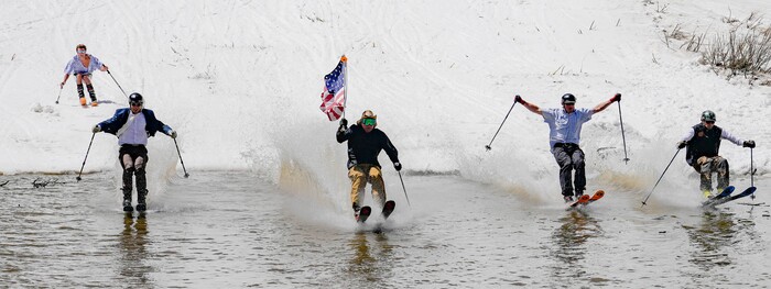 (Francisco Kjolseth  | The Salt Lake Tribune) Skiers skim the pond in Peruvian Gulch as Snowbird closes the book on the 2024-25 ski season on Monday, May 26, 2025. Snow and sun revelers took to the slushy slopes on Memorial Day as the resort was the last in the state to close.