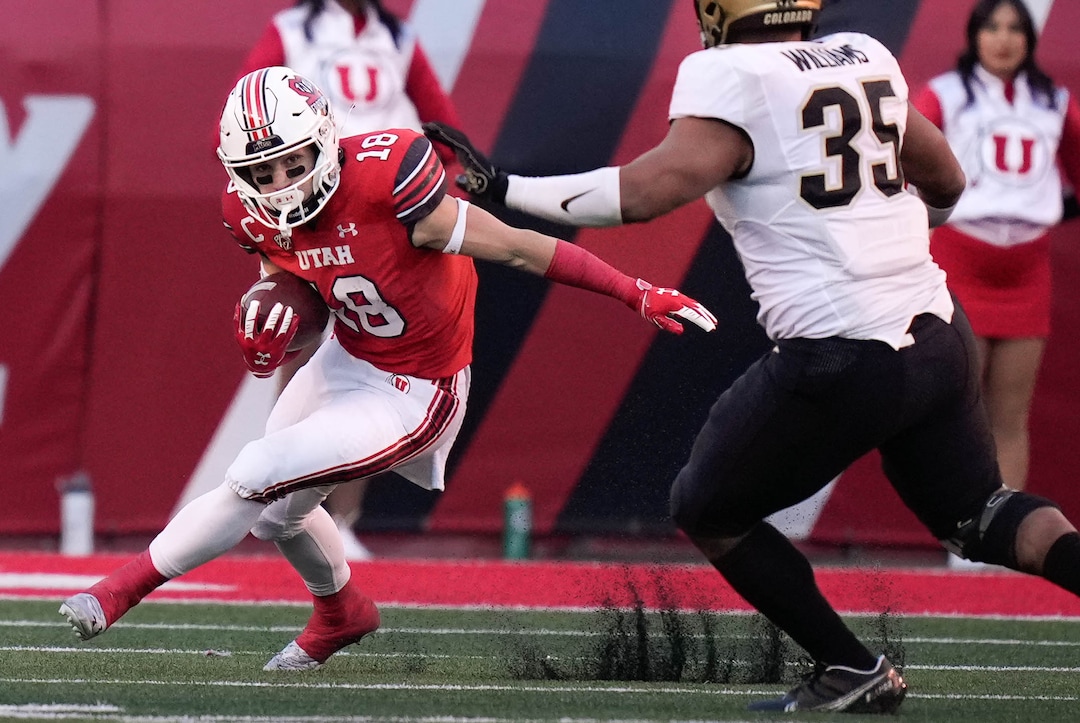 (Francisco Kjolseth | The Salt Lake Tribune) Utah Utes wide receiver Britain Covey (18) tries to maneuver around Colorado Buffaloes linebacker Mister Williams (35) as the University of Utah hosts the Colorado Buffaloes in Pac-12 football, Friday, Nov. 26, 2021 at Rice-Eccles Stadium.
