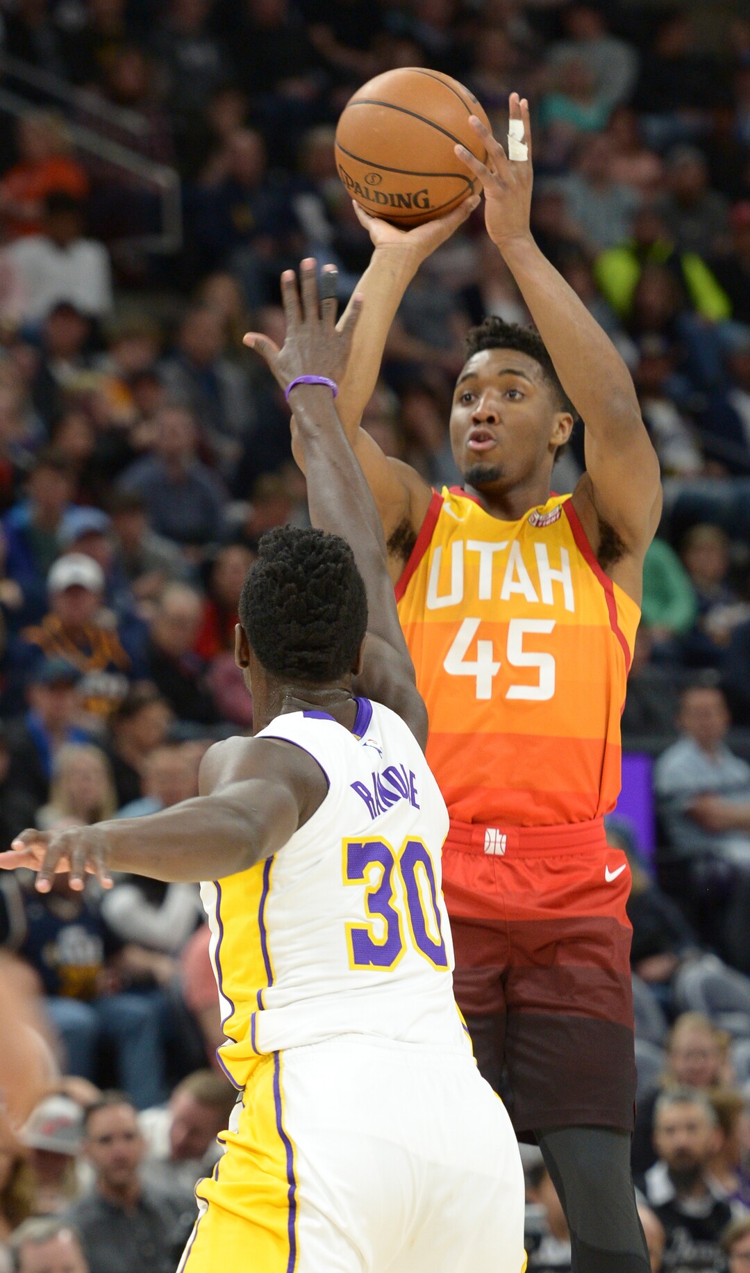 (Leah Hogsten  |  The Salt Lake Tribune) Utah Jazz guard Donovan Mitchell (45) hits a 3-point shot over Los Angeles Lakers forward Julius Randle (30) as the Utah Jazz host the Los Angeles Lakers at Vivint Smart Home Arena Tuesday, April 3, 2018