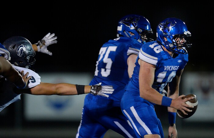 (Scott Sommerdorf | The Salt Lake Tribune) Pleasant Grove QB Jake Jensen is flushed out of the pocket as Corner Canyon DL Jackson Light late in the second half. Corner Canyon defeated Pleasant Grove 31-10 to start the season, Friday, August 18, 2017.