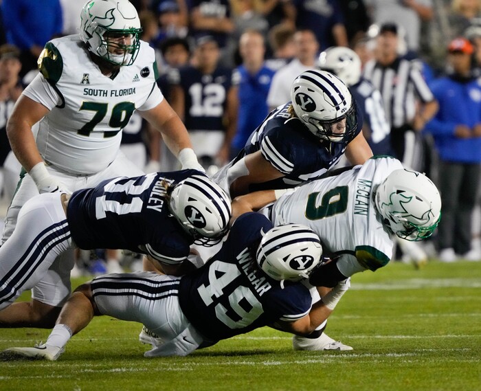 (Francisco Kjolseth | The Salt Lake Tribune) South Florida Bulls quarterback Timmy McClain (9) is taken down by the defensive line in game action between the Brigham Young Cougars and the South Florida Bulls at LaVell Edwards Stadium in Provo, Saturday, Sept. 25, 2021.