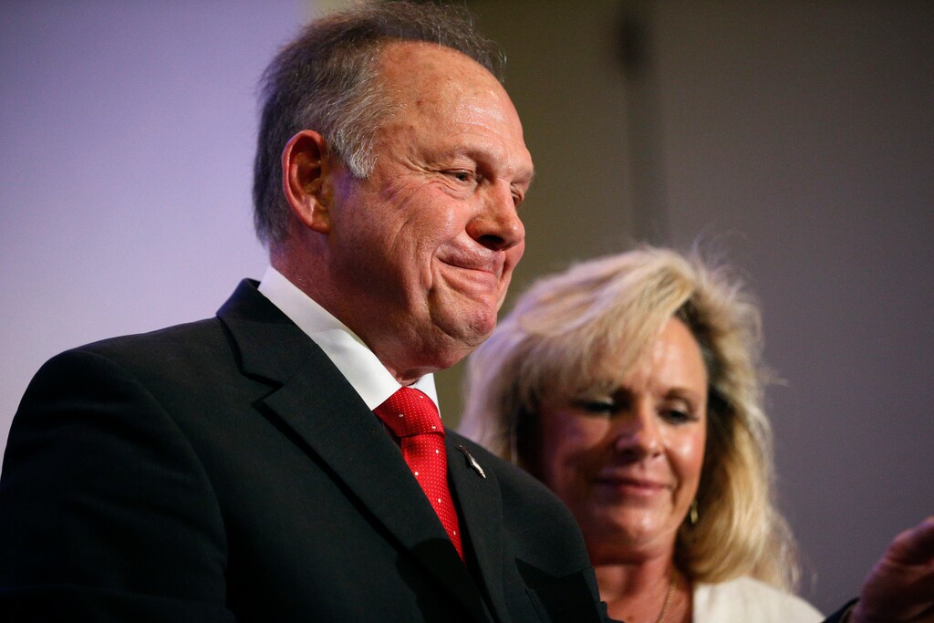 Former Alabama Chief Justice and U.S. Senate candidate Roy Moore speaks at a news conference, Thursday, Nov. 16, 2017, in Birmingham, Ala., with his wife Kayla Moore, right. (AP Photo/Brynn Anderson)