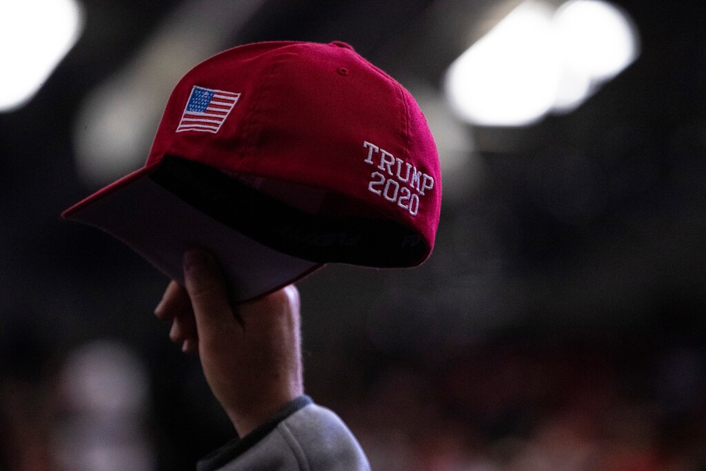 A supporter of President Donald Trump waves a "TRUMP 2020" hat during a campaign rally in Wildwood, N.J., on Tuesday, Jan. 28, 2020. "One essential lesson of the Trump era is that likelihoods are not enough; if you want to end the Trump era only one thing will suffice. You have to beat him," writes Ross Douthat. (Calla Kessler/The New York Times)