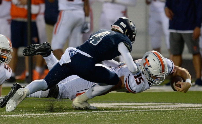 (Francisco Kjolseth  |  The Salt Lake Tribune)  Jacob Boscow of Timpview manages extra yards as Luke Cahoon of Corner Canyon moves in during game action at Corner Canyon on Thursday, Sept. 21, 2017.