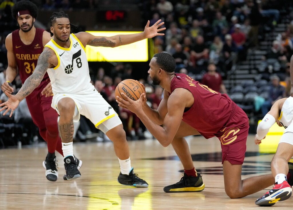 (Francisco Kjolseth | The Salt Lake Tribune) Cleveland Cavaliers forward Evan Mobley (4) regains control of the ball as Utah Jazz forward Brice Sensabaugh (8) moves in at the Delta Center in Salt Lake City on Tuesday, April 2, 2024.
