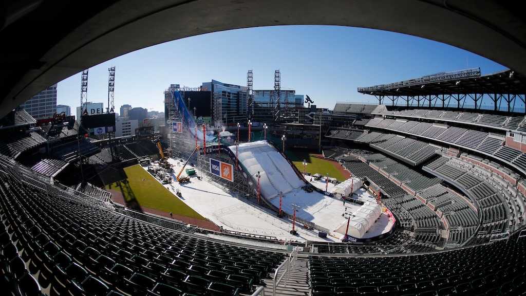 Crews work to construct and cover a giant ski slope with snow on the playing field at SunTrust Park Wednesday, Dec. 18, 2019, in Atlanta. The baseball stadium, home of the Atlanta Braves, will host the Big Air ski and snowboard competition Friday and Saturday. (AP Photo/John Bazemore)