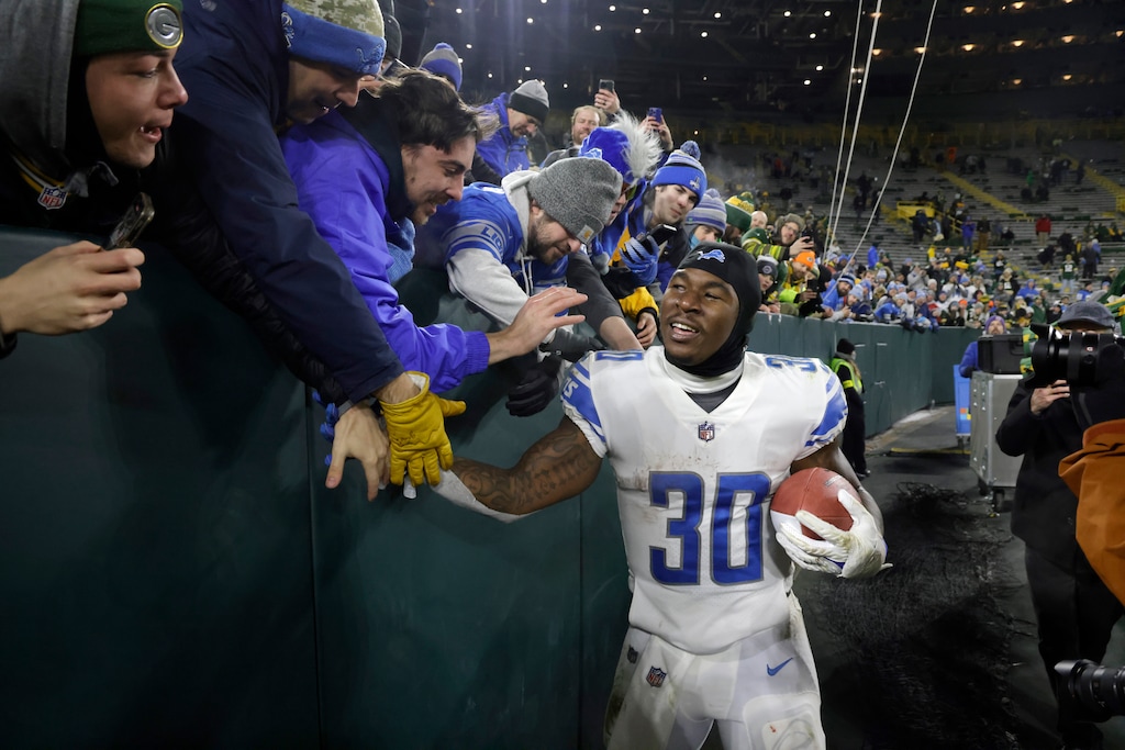 (Mike Roemer | AP) Detroit Lions running back Jamaal Williams celebrates with fans following an NFL football game against the Green Bay Packers Sunday, Jan. 8, 2023, in Green Bay, Wis. The Lions won 20-16.