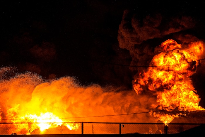 (Chris Detrick  |  The Salt Lake Tribune)  Firefighters attempt to put out a burning semitrailer that was hauling thousands of gallons of fuel on Interstate-15 in Midvale Thursday, January 18, 2018.   Lt. Todd Royce of the Utah Highway Patrol said the truck was southbound on the interstate at 7500 South at 7:20 p.m. when a tire caught fire, sending flames toward the tanks.