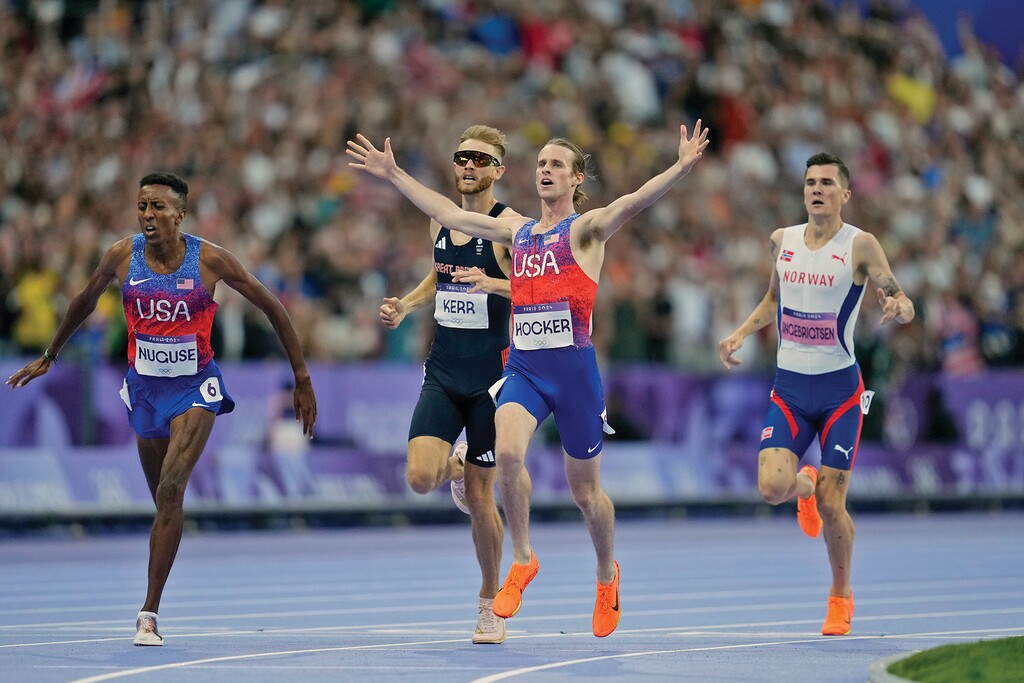 Cole Hocker, of the United States, crosses the finish line ahead of Josh Kerr, of Britain, Yared Nuguse, of the United States, and fourth placed Jakob Ingebrigtsen, of Norway, to win the men's 1500 meters final at the 2024 Summer Olympics, Tuesday, Aug. 6, 2024, in Saint-Denis, France. (AP Photo/Ashley Landis)