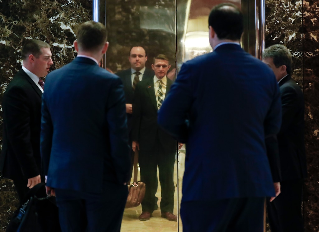 (Carolyn Kaster | The Associated Press) Retired Lt. Gen Michael Flynn, center right, and Boris Epshteyn, a spokesman for President-elect Donald Trump, center left, are reflected in elevator doors Flynn arrives at Trump Tower, Thursday, Nov. 17, 2016, in New York.