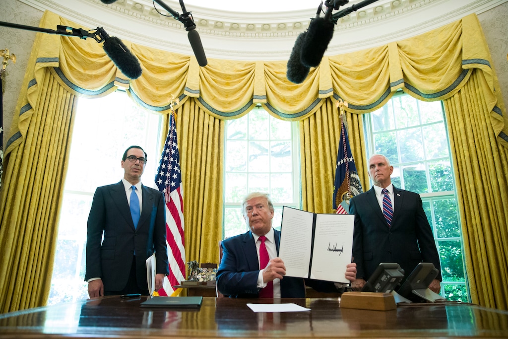 (Alex Brandon | AP file photo) President Donald Trump holds up a signed executive order to increase sanctions on Iran, in the Oval Office of the White House in Washington on June 24, 2019, with Treasury Secretary Steven Mnuchin, left, and Vice President Mike Pence. The International Monetary Fund said in a report published Monday, Oct. 28, 2019, that political uncertainty and volatile oil prices are hindering economic growth in the Middle East this year. The region is reeling from U.S. sanctions on Iran and last month's attack on the world's largest oil processor in Saudi Arabia.