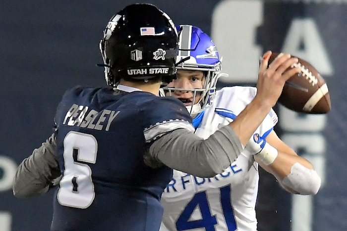 Utah State quarterback Andrew Peasley (6) looks to throw the ball as Air Force linebacker Matthew Malloy (41) defends during the first half of an NCAA college football game Thursday, Dec. 3, 2020, in Logan, Utah. (Eli Lucero/The Herald Journal via AP, Pool)