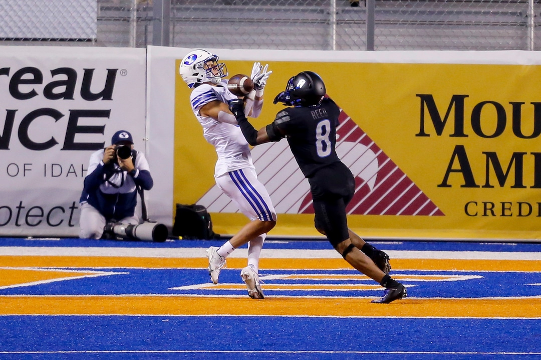BYU wide receiver Dax Milne, left, tries to pull in a pass as Boise State cornerback Markel Reed (8) defends in the end zone during the first half of an NCAA college football game Friday, Nov. 6, 2020, in Boise, Idaho. Reed was called for pass interference. (AP Photo/Steve Conner)