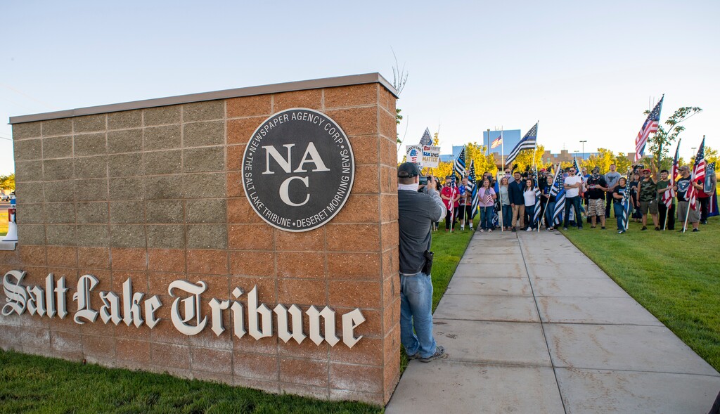 (Rick Egan  |  The Salt Lake Tribune)     Police supporters upset by a Pat Bagley cartoon pose for a group photos after protesting The Salt Lake Tribune, in West Valley City, on Thursday, Sept. 3, 2020.