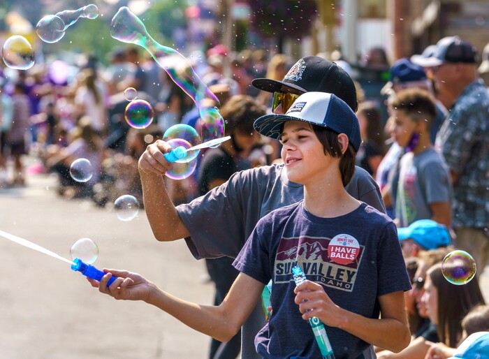 (Leah Hogsten | The Salt Lake Tribune) Jake Broussard, 14, of Park City blows bubbles with his friend Ben Hoffman, 14, as the town celebrates Labor Day, Sept. 6, 2021 paying tribute to the townÕs mining heritage during its 125th anniversary celebration of MinersÕ Day.