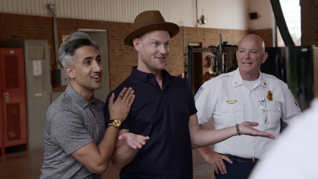 (Photo courtesy of Netflix) Tan France, Bobby Berk and the fire chief in the “Hose Before Bros” episode of “Queer Eye.”