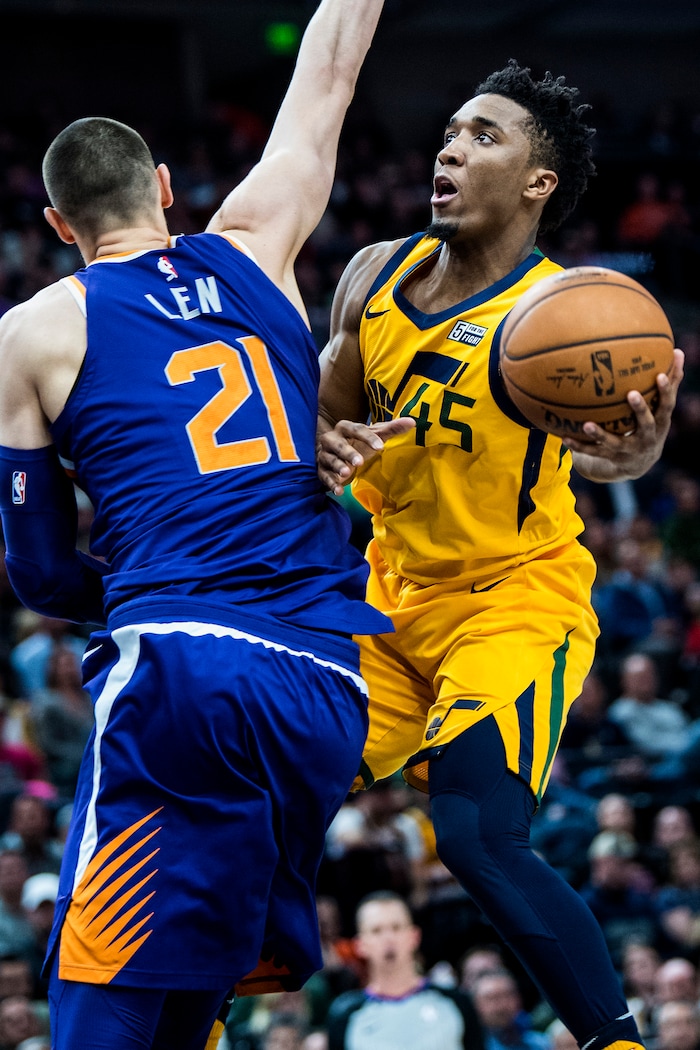(Chris Detrick  |  The Salt Lake Tribune)  Utah Jazz guard Donovan Mitchell (45) shoots past Phoenix Suns center Alex Len (21) during the game at Vivint Smart Home Arena Thursday, March 15, 2018. Utah Jazz defeated Phoenix Suns 116-88.