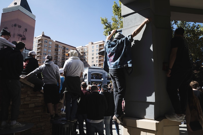 (Clark Clifford  |  Special to The Salt Lake Tribune) An individual attempts to scale the building for a better view of Kanye West's Sunday Service at The Gateway in Salt Lake City on Saturday, Oct. 5, 2019.