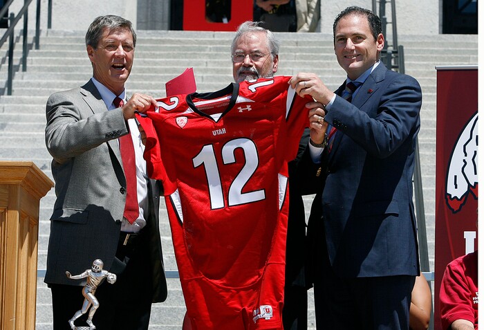 (Scott Sommerdorf  |  Tribune File Photo)  Utah athletic director Chris Hill, left, Utah interim president Lorris Betz, and Pac-12 commissioner Larry Scott hold up a football jersey commemorating the day as the University of Utah officially became a member of the Pac-12 conference on July ,1 2011.