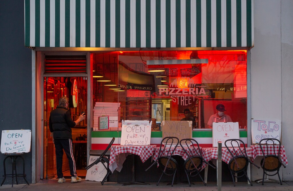 (Damian Dovarganes | AP) The Mulberry Street Pizzeria is seen open for delivery only in Beverly Hills, Calif., on Wednesday, April 15, 2020. The world's biggest economy began issuing one-time payments this week to tens of millions of people as part of its $2.2 trillion coronavirus relief package, with adults receiving up to $1,200 each and $500 per child to help them pay the rent or cover other bills. The checks will be directly deposited into accounts or mailed to households in the coming weeks, depending on how people filed their tax returns.