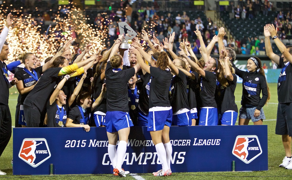 FC Kansas City celebrate with the trophy after the NWSL soccer championship match in Portland, Ore., Thursday, Oct. 1, 2015. FC Kansas City won the match 1-0. (AP Photo/Craig Mitchelldyer)
