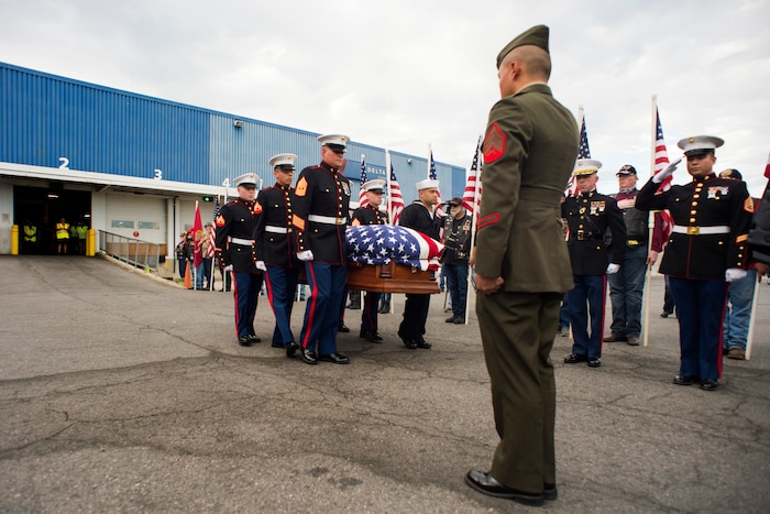 (Rick Egan  |  The Salt Lake Tribune)      The remains of Marine Pfc. Robert K. Holmes are carried from the Delta Air Cargo to a hearse for transportation to the mortuary.  Holmes died aboard the USS Oklahoma during the attack on Pearl Harbor. Friday, Aug. 17, 2018.