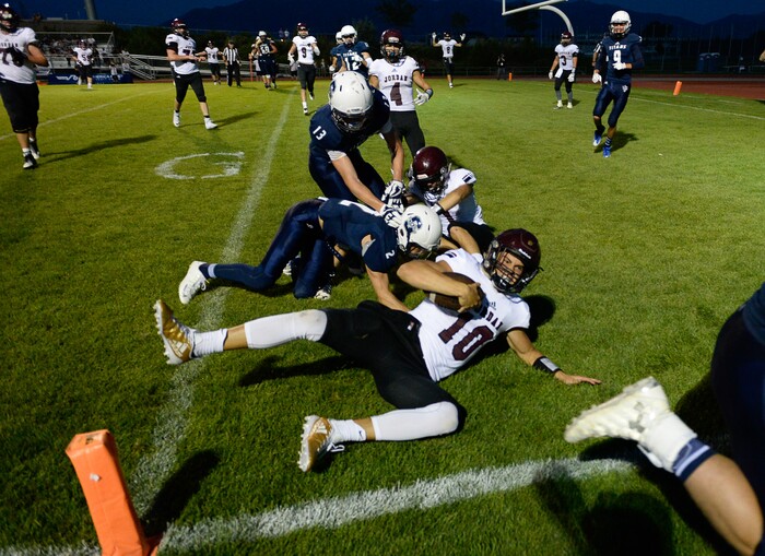 (Francisco Kjolseth  |  The Salt Lake Tribune)  Jordan quarterback Crew Wakley runs the ball into the end zone for a touchdown in the third quarter against Syracuse in game action at Syracuse on Thursday, Aug. 24, 2017.