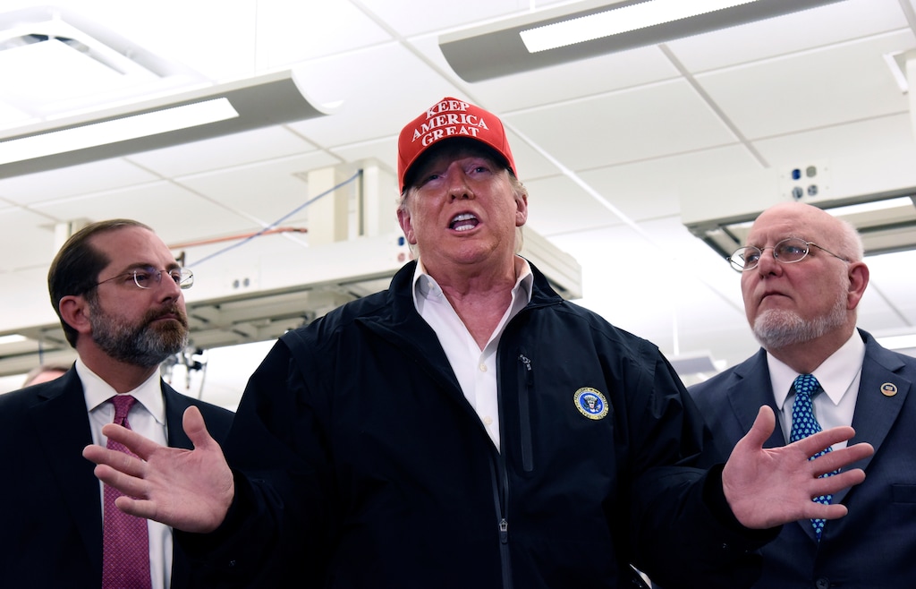 President Donald Trump speaks to members of the press as Health and Human Services Secretary Alex Azar, left, and CDC Director Robert Redfield, right, at the headquarters of the Centers for Disease Control and Prevention in Atlanta on Friday, March 6, 2020. (Hyosub Shin/Atlanta Journal-Constitution via AP)