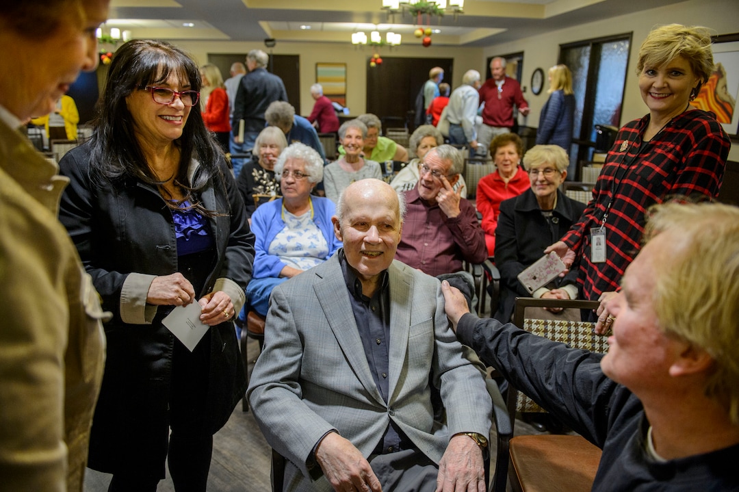 (Steve Griffin  |  The Salt Lake Tribune) Paul Christensen  visits with some of his former students following a Christmas concert at Cottonwood Place senior living community in Holladay Friday December 15, 2017. During the concert the Salt Lake Education Foundation presented a new scholarship in his honor. For 30 years, Christensen inspired generations of students at Highland High School to pursue their musical talents as the lively choral director of the schoolÕs many music programs.