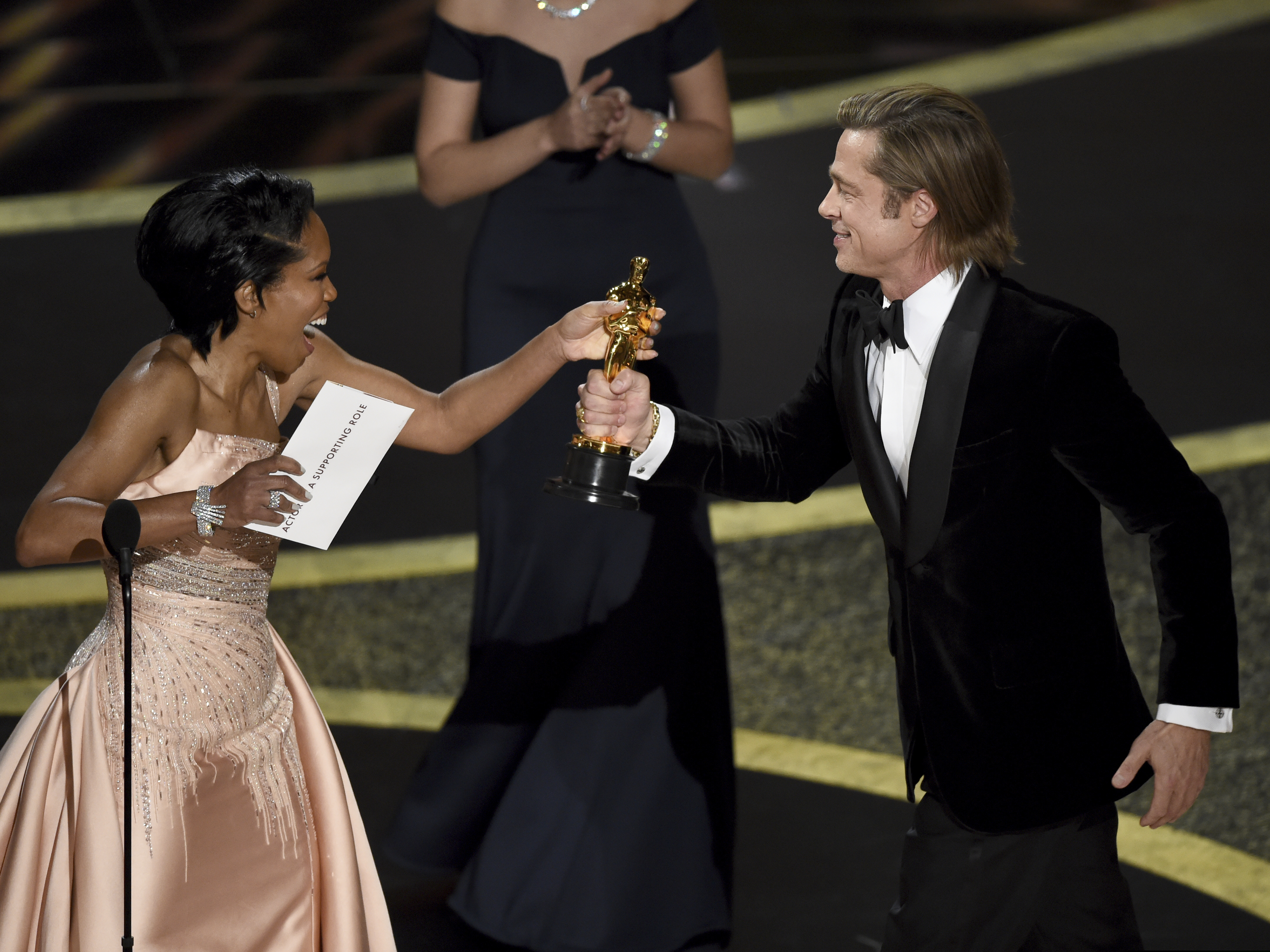 (Chris Pizzello | AP)  Regina King, left, presents Brad Pitt with the award for best performance by an actor in a supporting role for "Once Upon a Time in Hollywood" at the Oscars on Sunday, Feb. 9, 2020, at the Dolby Theatre in Los Angeles.
