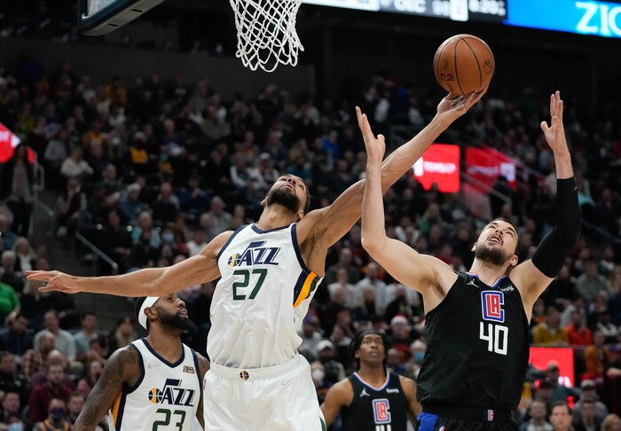 (Francisco Kjolseth | The Salt Lake Tribune) Utah Jazz center Rudy Gobert (27) uses his extensive wingspan on a rebound against LA Clippers center Ivica Zubac (40) in NBA action between the Utah Jazz and the LA Clippers at Vivint Smart Home Arena in Salt Lake City, Wednesday, Dec. 15, 2021.