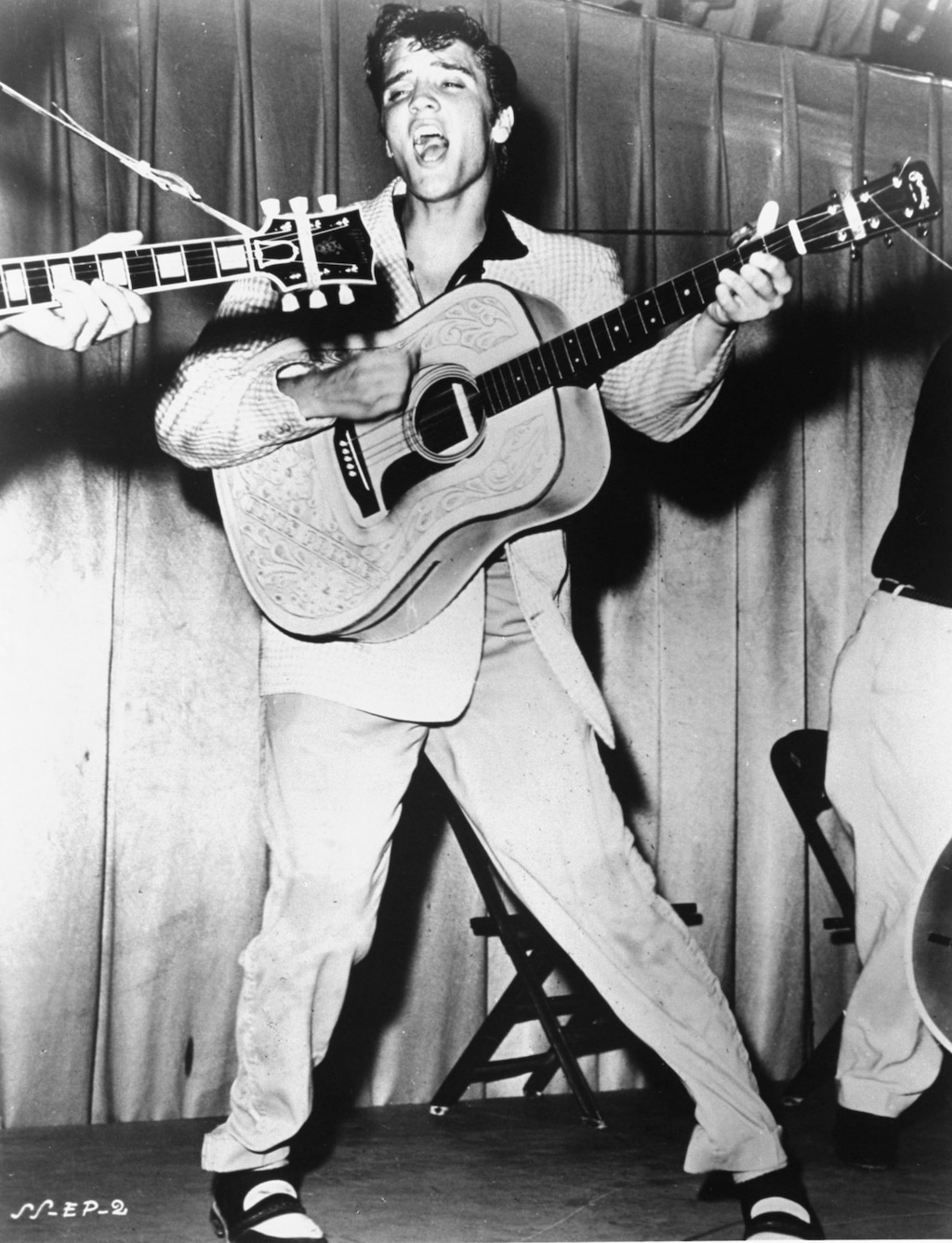 (The Associated Press) This is a 1956 photo of Elvis Presley performing.  This photo was used for his first RCA Victor album cover.