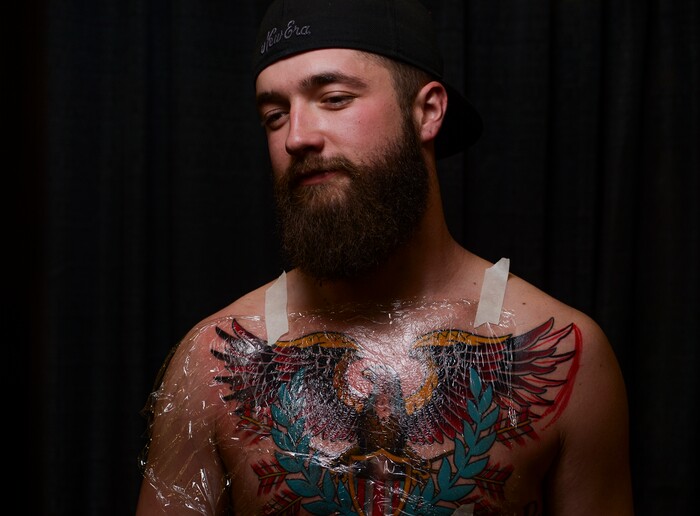 (Leah Hogsten | The Salt Lake Tribune) "I'm a free bird," said Dustin Bitton of Salt Lake City showing off his new tattoo on his chest to cover up the name of his soon-to-be ex-wife at the Salt Lake City International Tattoo Convention Saturday, March 17, 2018. "The divorce is final at the end of the month," said Bitton.