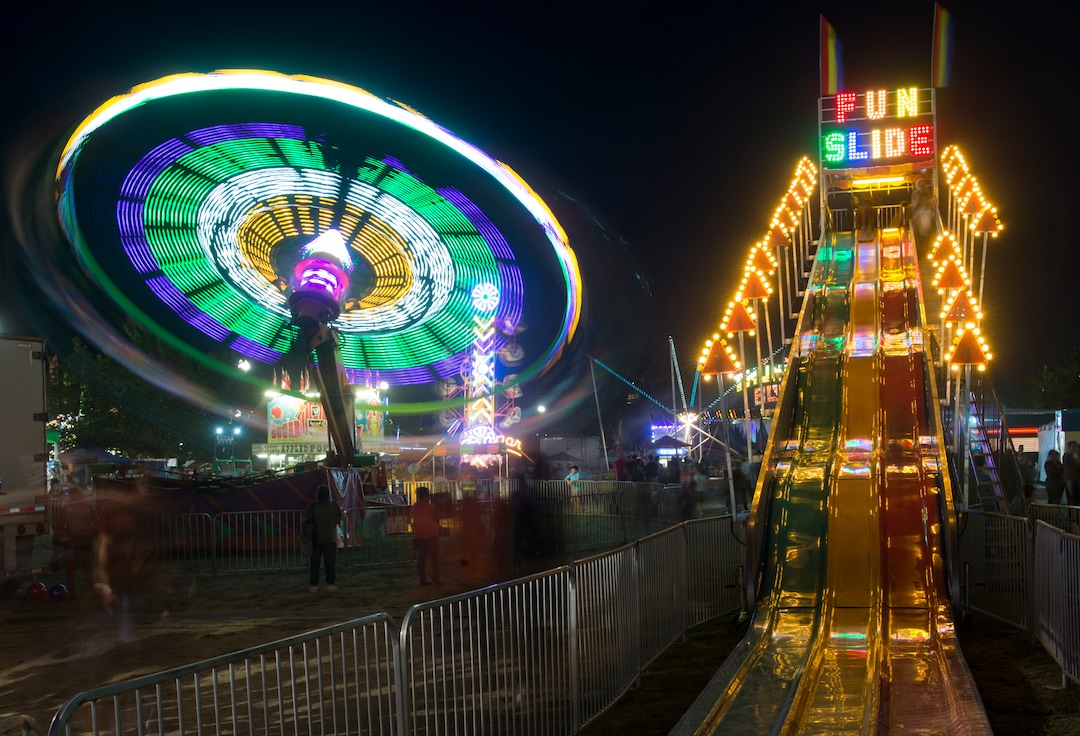 (Rick Egan  |  The Salt Lake Tribune)   The Cliff Hanger and the Fun Slide light up the midway at the Utah State Fair, on a busy Monday evening , Sept. 10, 2018.