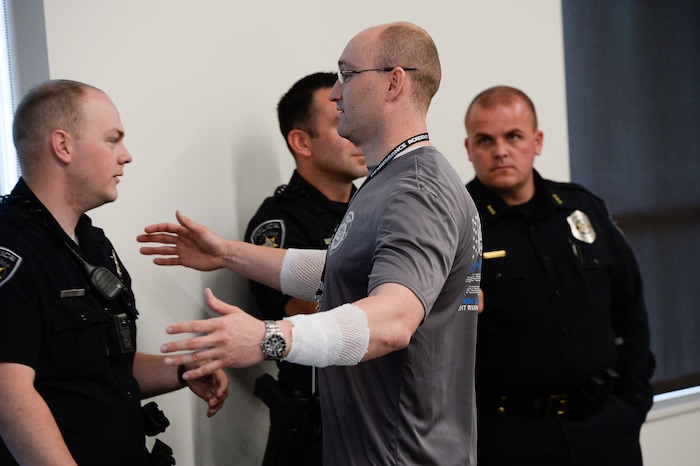 (Francisco Kjolseth  |  The Salt Lake Tribune)  Kaysville Officer Cade Bradshaw, center, embraces fellow officers following a press event to describe the events on April 5, 2018, when a man entered a Chevron gas station store and doused himself with gasoline, injuring Bradshaw and three other officers. 