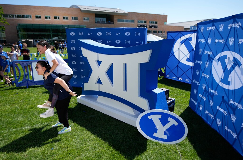 (Francisco Kjolseth | The Salt Lake Tribune) Jerraine Dunn and Amelia become animated for a fast moving video camera as BYU celebrates their entrance into the Big 12 Conference with a big party on campus on Saturday, July 1, 2023.