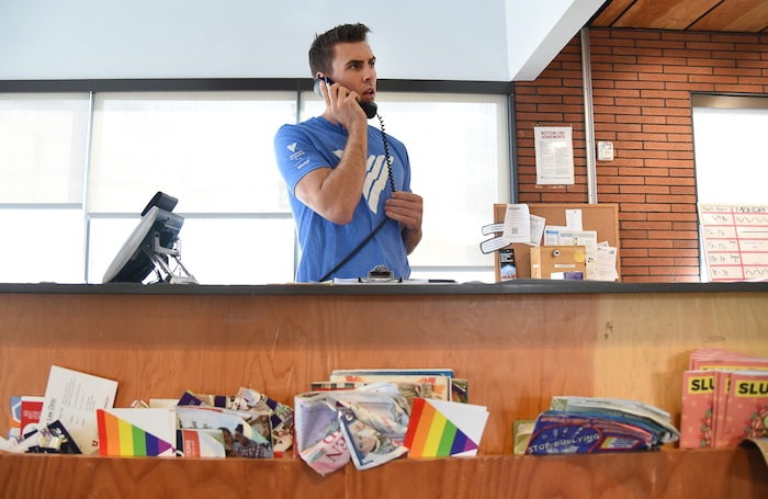 (Francisco Kjolseth | The Salt Lake Tribune) Ballet West dancer Lucas Horns answers the phone and runs through numerous tasks as he takes a turn at the front desk during one of his Sunday volunteer shifts at the VOA Youth Resource Center in Salt Lake City. Horns who started volunteering over two years ago, also leads an LGBTQ support group.