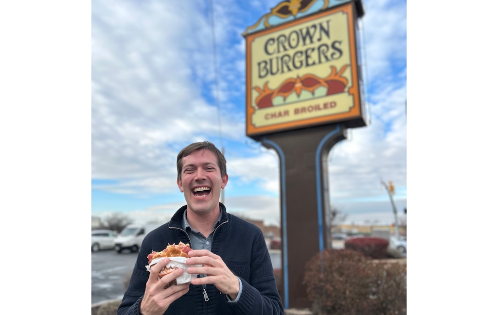 (Ali Vallarta) Bryant Heath stands in front of the Crown Burgers sign at the local chain's West Valley City location.