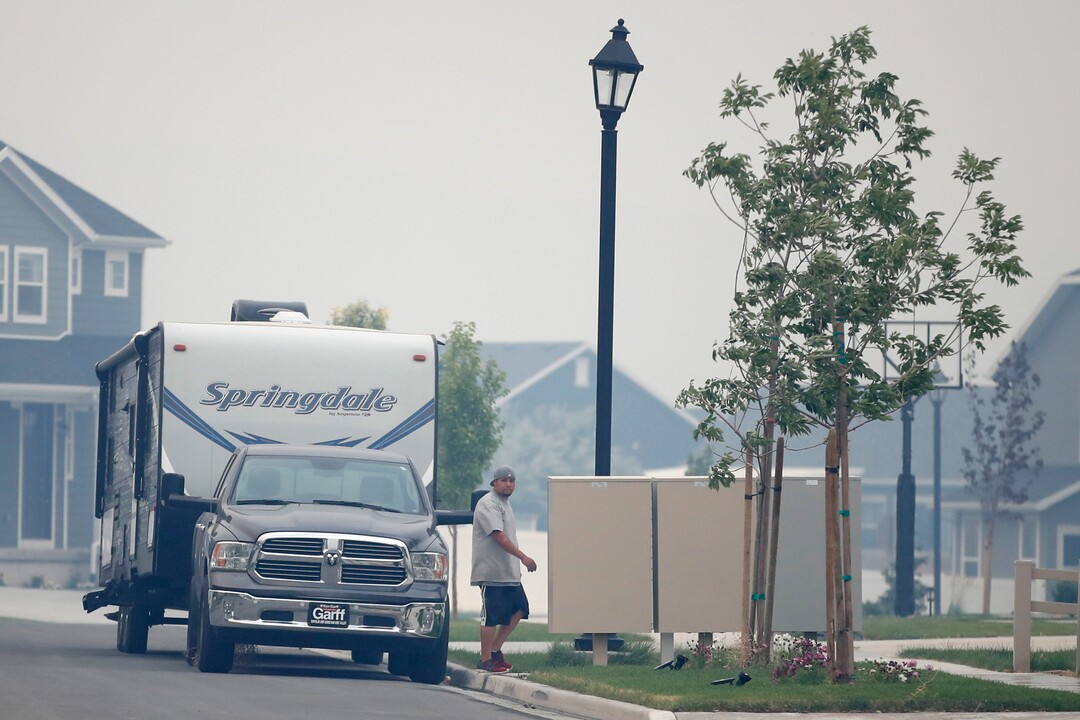 (George Frey  |  for The Salt Lake Tribune) A man loads his RV with belongings in case he is ordered to evacuate from his home in south Saratoga Springs due to a wildfire on June 28, 2020.