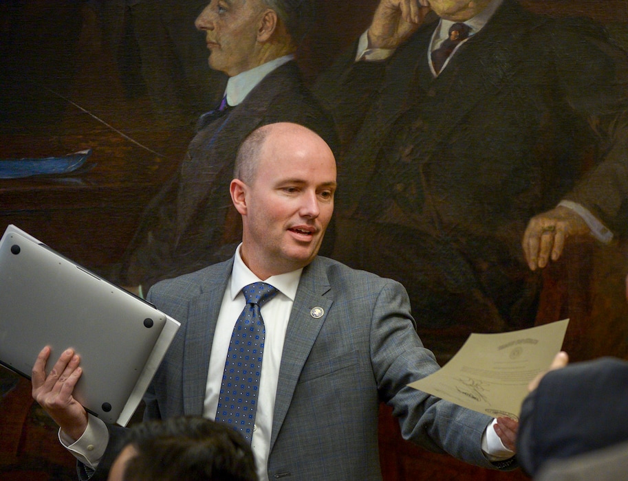 (Leah Hogsten  |  Tribune file photo)   Utah Lt. Gov. Spencer Cox hands over the certified election results decree signed by fellow members of the state board of canvassers, Nov. 26, 2018 in the Utah Capitol boardroom.