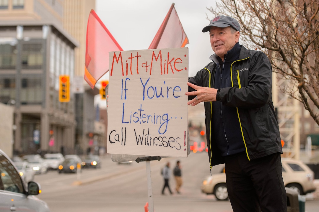 (Trent Nelson  |  The Salt Lake Tribune) Kreg Calder holds a sign up to passing traffic as a coalition of progressive groups gathered Thursday outside the federal building in Salt Lake City on Thursday, Jan. 16, 2020 to push for a fair and impartial Senate impeachment hearing against President Donald Trump.
