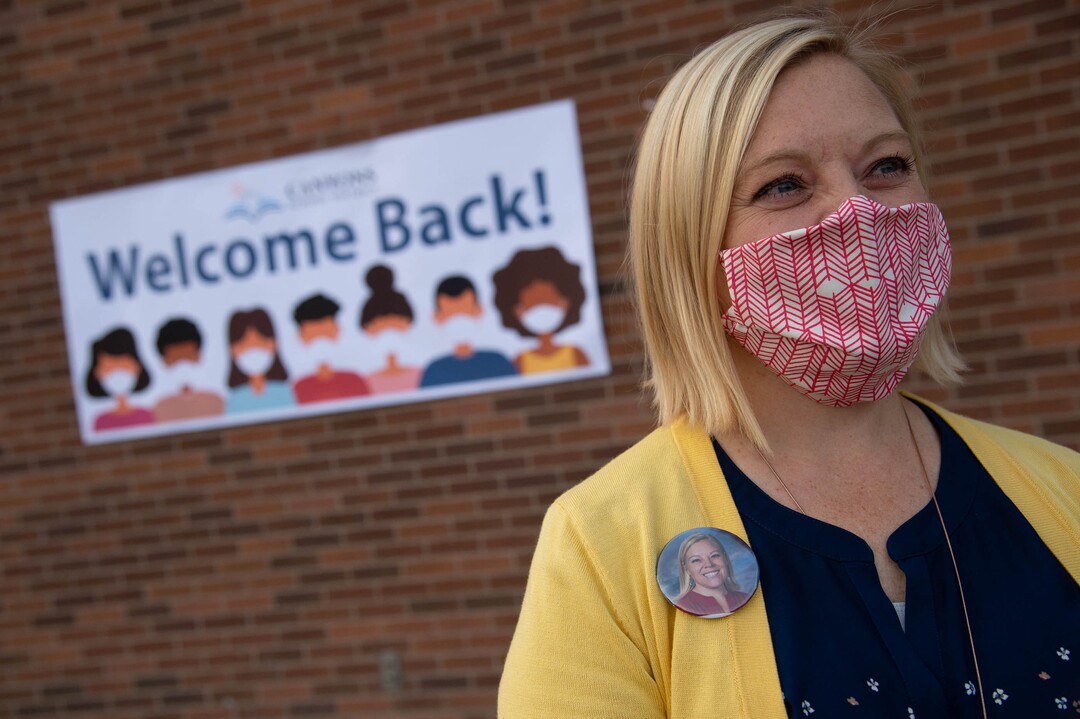 (Francisco Kjolseth  |  The Salt Lake Tribune) Canyon View Elementary School principal Kierstin Draper sports a pin with her picture made for all the staff by the PTA as she gets ready to greet incoming students in Cottonwood Heights for the first day classes for the Canyons School District on Monday, August 24, 2020.