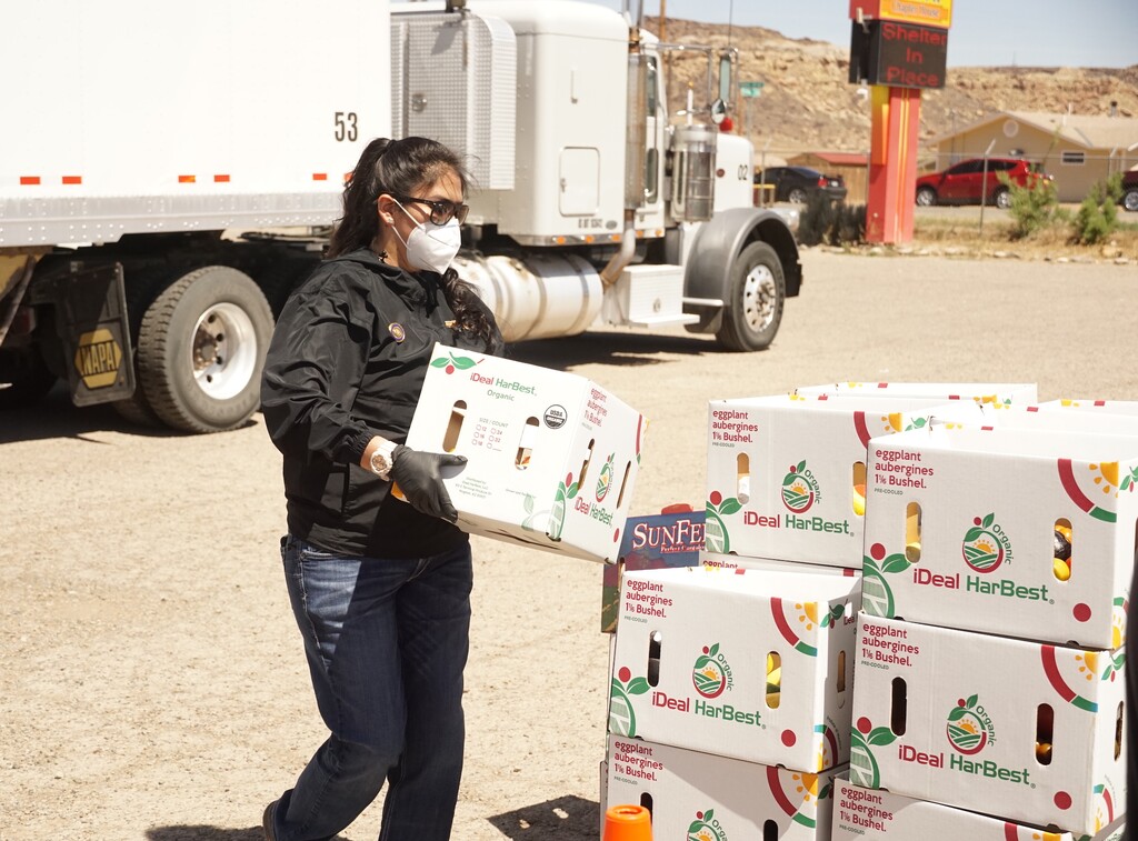 (Zak Podmore | The Salt Lake Tribune) Navajo Nation Council Delegate Charlaine Tso stacks donated food at a coronavirus relief event in Aneth on Thursday, May 14, 2020.