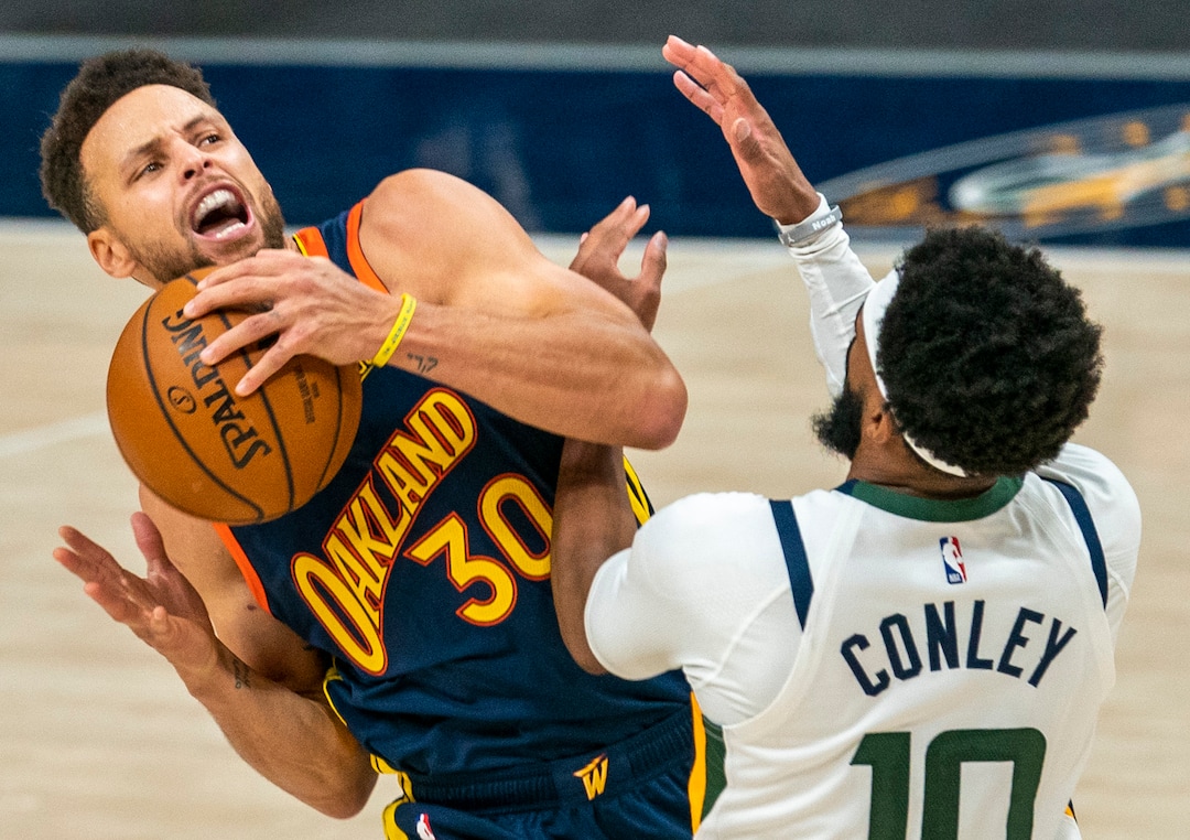 (Rick Egan | The Salt Lake Tribune) Golden State Warriors guard Stephen Curry (30) manages to score and draw a foul as he collides with Utah Jazz guard Mike Conley (10), in NBA action between the Utah Jazz and the Golden State Warriors at Vivint Arena, on  Saturday, Jan. 23, 2021.