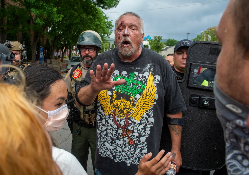 (Rick Egan  |  The Salt Lake Tribune)    Brandon McCormick shouts at protesters after he was beaten up for allegedly brandishing a bow and arrow, after driving his car into the crowd, Saturday, May 30, 2020.
