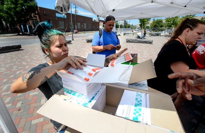 (Steve Griffin  |  The Salt Lake Tribune)  Volunteers Crystal Yazzie, Damon Harris and Jenna Vitdenhowen help members from the Utah Harm Reduction Coalition as they exchange needles on 500 West between 200 South and 300 South in Salt Lake City Thursday, July 27, 2017. The state's increased attention to the Rio Grande neighborhood comes as Utah's leading needle-exchange provider is under fire for handing out more needles than it collects. Mindy Vincent, founder of the coalition, says the goal was never to break even, and that optics aside, needle exchange is proven to reduce the spread of disease among IV drug users.